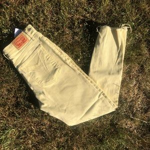 Yellow Levi raw hem skinny jeans